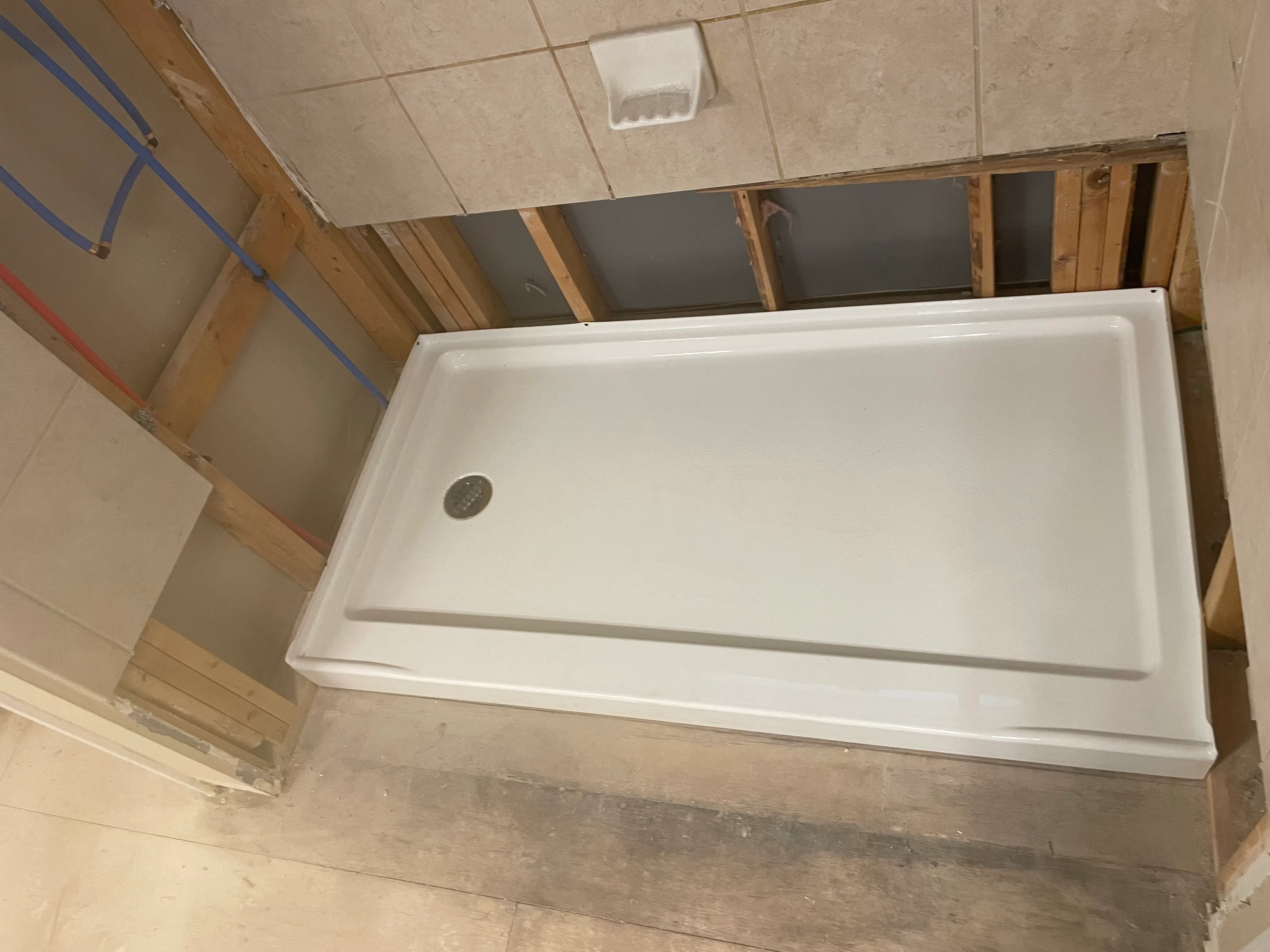 New shower base installed in a bathroom renovation